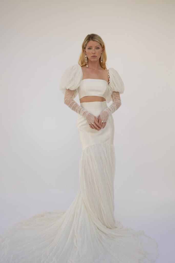 Cinq's wedding dress designs give a vintage feeling while being modern and timeless. This piece is a long puffed sleeve, two piece wedding gown.